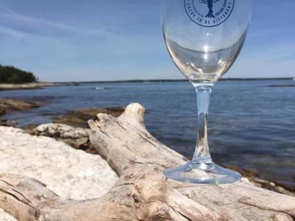 The Blue Lobster wine glass on log