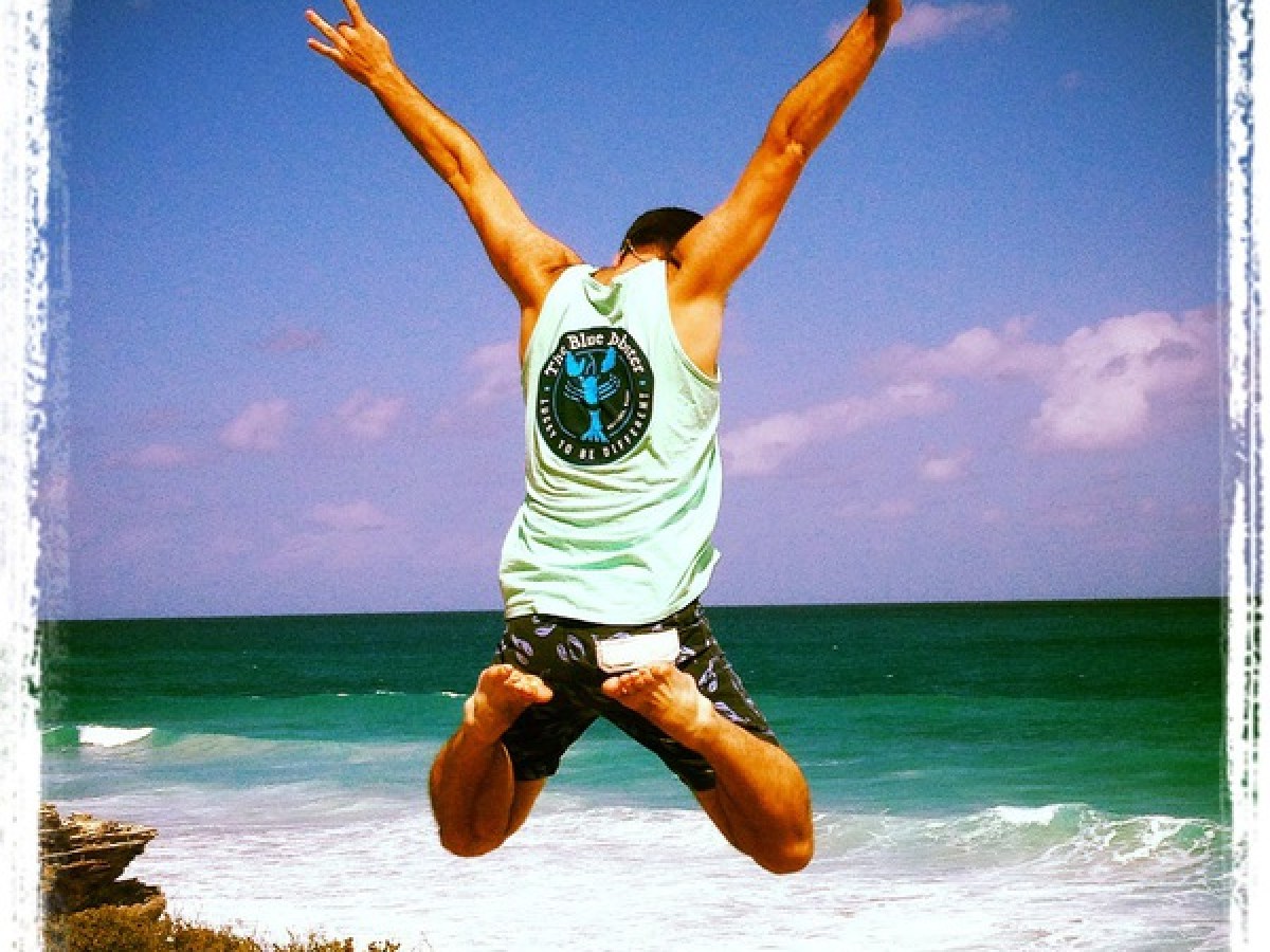 Man jumping with The Blue Lobster shirt on