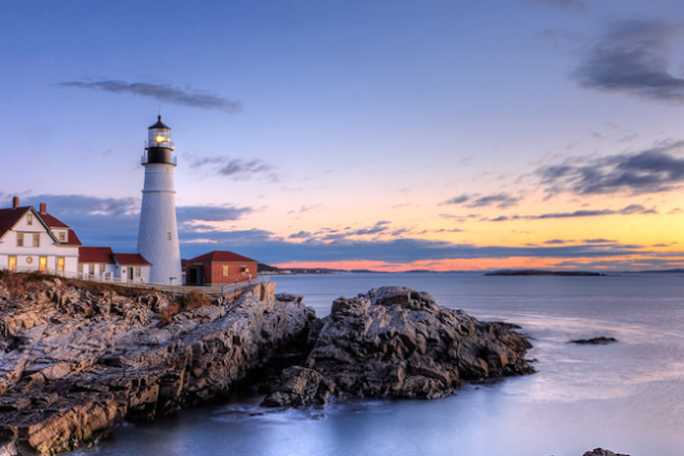 Maine lighthouse with sunset in background