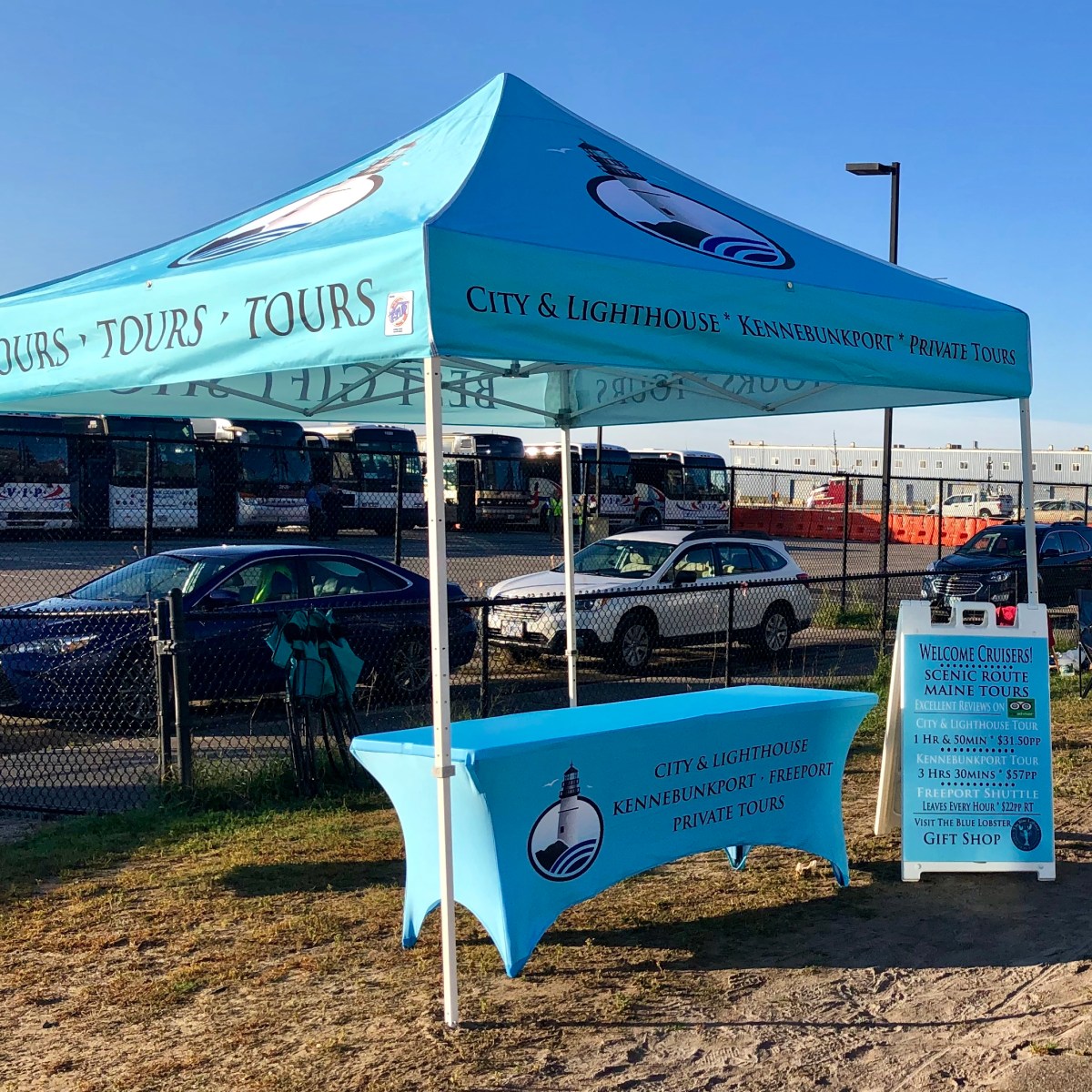 a blue sign in front of a fence